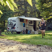 Camper van parked in a mountainous area with people around
