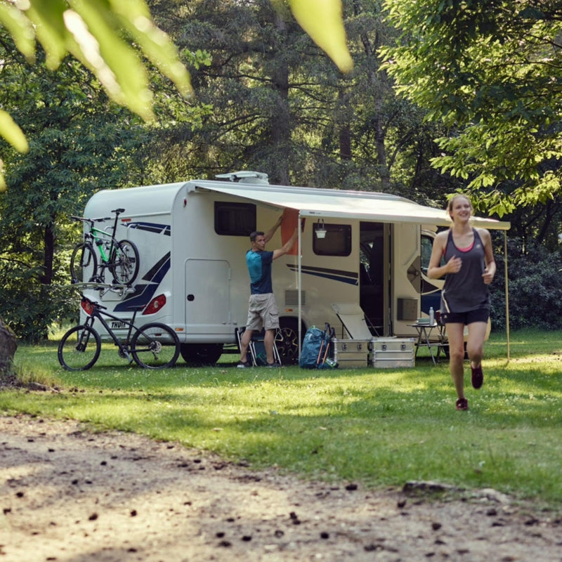 Camper van parked in a mountainous area with people around