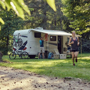 camper van parked in a mountainous area with people around
